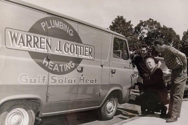 The founders beside the original Warren J. Gottier Plumbing and Heating van, 1960s